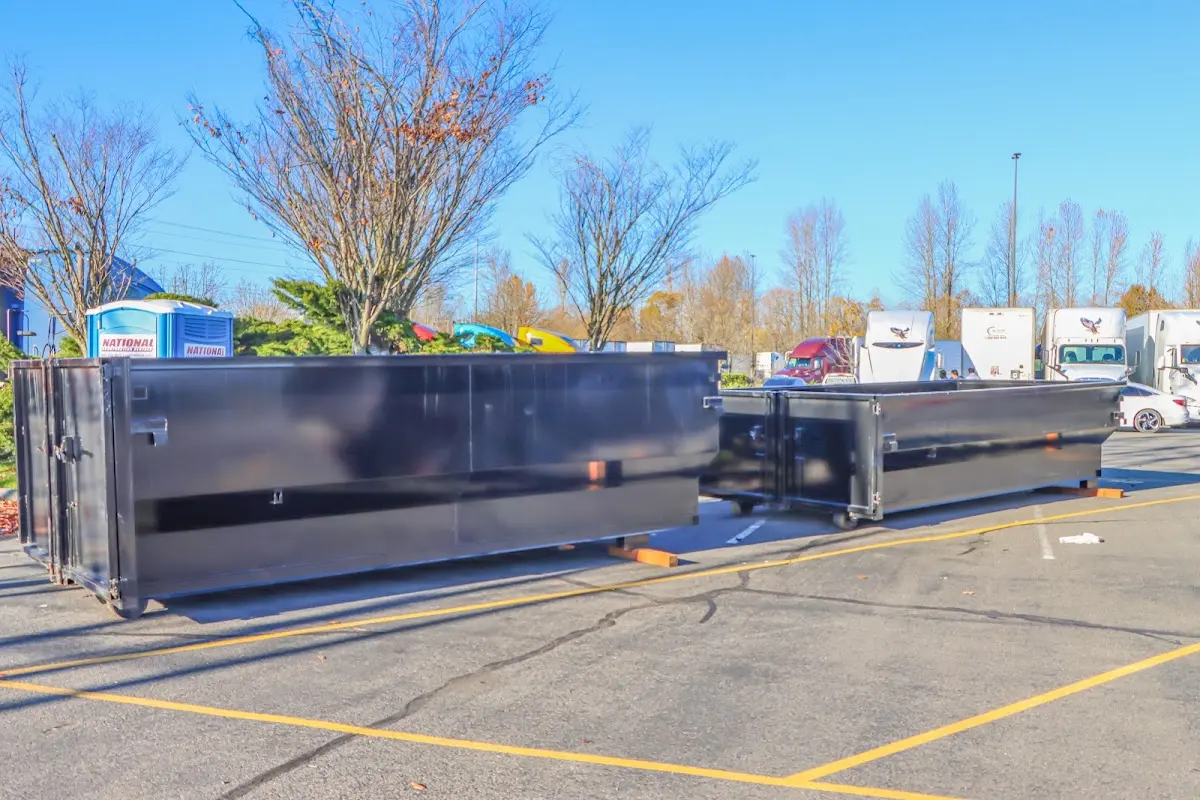 Professional dumpster rental service with roll-off container on residential driveway in Sunland Park